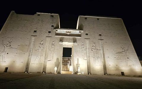 Templo de Edfu dedicado ao deus Hórus, Egito, com turistas acompanhados de guia em português admirando as paredes decoradas com hieróglifos e a arquitetura antiga tour exclusivo no Egito